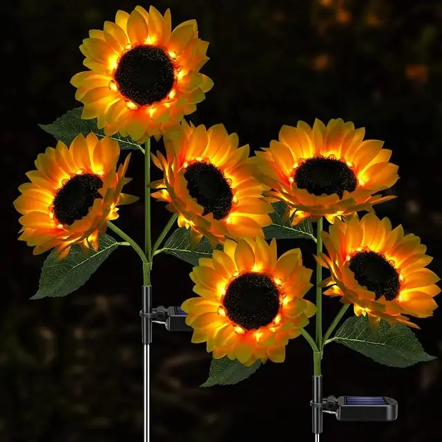 Meagoo solar sunflower lights glowing yellow in an outdoor garden at night